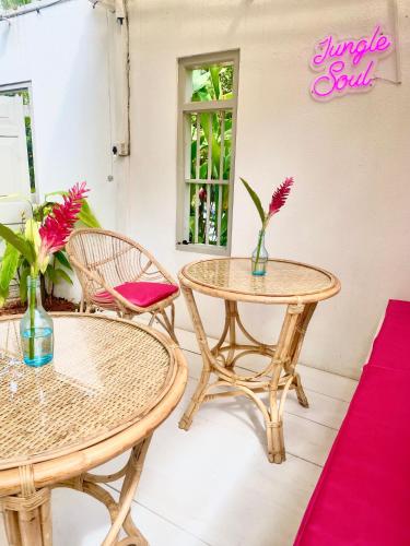 two tables and chairs and a sign that reads jungle salon at Jungle Soul in Mirissa