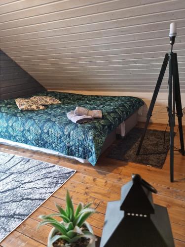 a bedroom with a bed and a tripod at Ostoja Karkonoska in Podgórzyn
