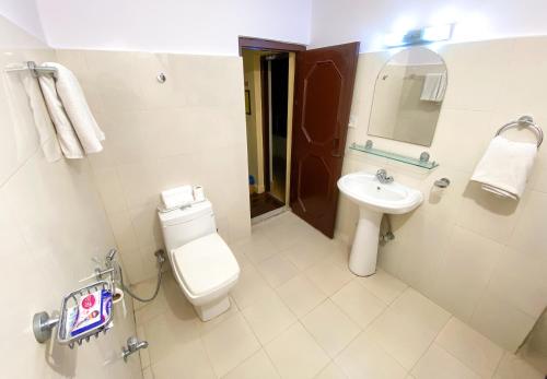 a bathroom with a toilet and a sink at Thamel Grand Hotel in Kathmandu