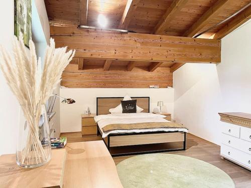 a bedroom with a bed and a wooden ceiling at whole villa Munich, Alps view, Quiet and spacious in Feldkirchen-Westerham