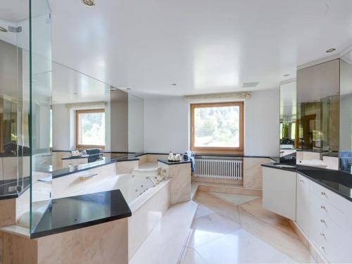a large bathroom with white counters and glass walls at whole villa Munich, Alps view, Quiet and spacious in Feldkirchen-Westerham