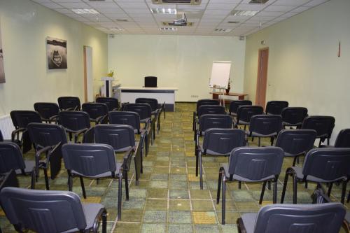 an empty room with chairs and a podium in it at Hotel-Restaurant Smilga in Kėdainiai