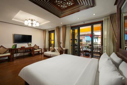 a bedroom with a bed and a living room at Hanoi Nostalgia Hotel & Spa in Hanoi