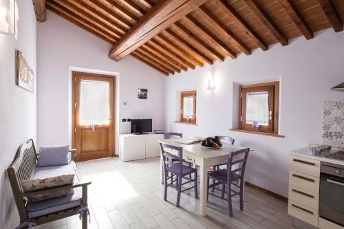 a kitchen and dining room with a table and chairs at Incanto Toscano in Larciano