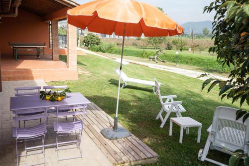 a table and chairs with an umbrella on a patio at Incanto Toscano in Larciano