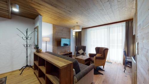a living room with a couch and a table at Apartmány iziJasná & Chalets in Demanovska Dolina