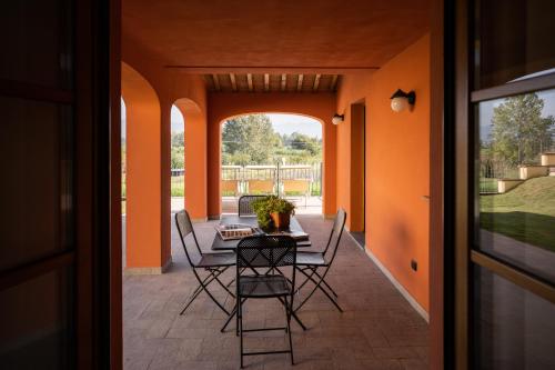 a table and chairs on a patio with an open door at Incanto Toscano in Larciano