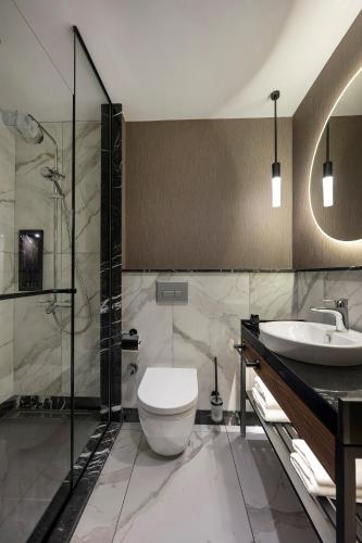a bathroom with a toilet and a sink at Livro Hotel in Istanbul