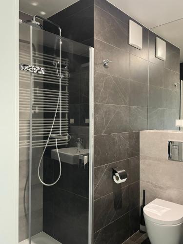 un bagno con doccia, WC e lavandino di visiting apartments - Wyspa Słodowa a Breslavia