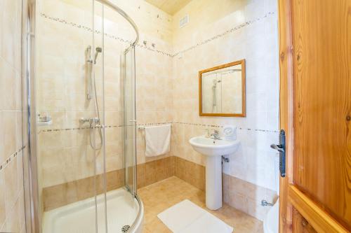 a bathroom with a shower and a sink and a toilet at The Blue House Holiday Home in Għasri