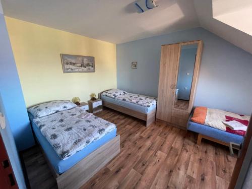 a small room with two beds and a mirror at Apartments Ubytování U Zemanů in Chrášťany