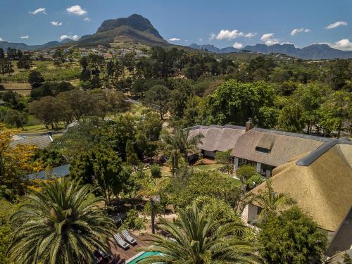 an aerial view of a house with trees and mountains at Africa Lodge in Somerset West