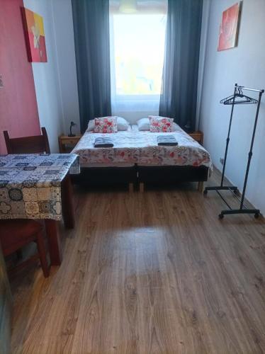 a bedroom with a bed and a table and a window at Ostoja Karkonoska in Podgórzyn