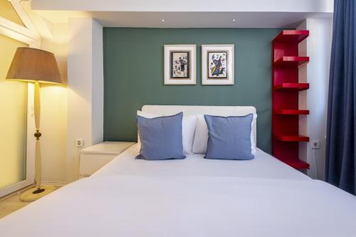 a bedroom with a large bed with blue walls at Centr in Istanbul