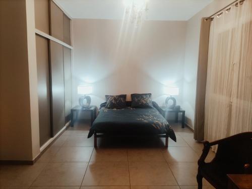 a bedroom with a bed with two pillows on it at 170 m² entre Lyon et St Etienne in Saint-Martin-la-Plaine