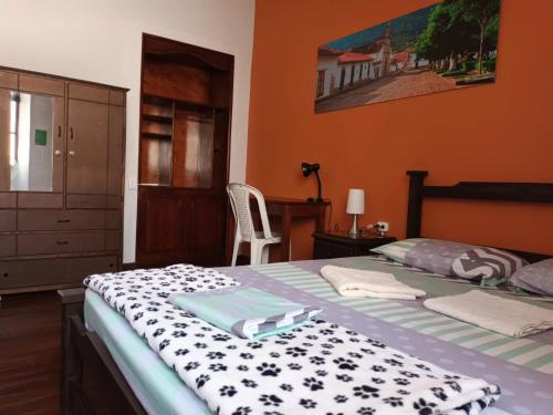 a bedroom with a bed with a black and white blanket at Caracol Casa Turística in San Gil