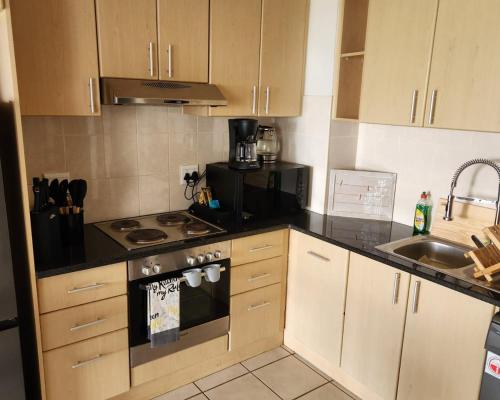 a small kitchen with a stove and a sink at 13 at Santos in Mossel Bay