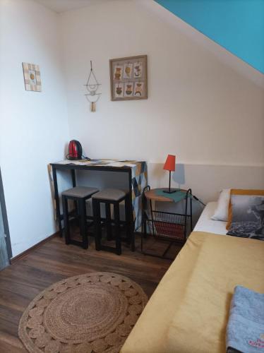a room with a bed and a table and chairs at Ostoja Karkonoska in Podgórzyn