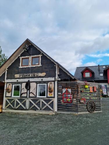 a log cabin with a sign on the side of it at Ostoja Karkonoska in Podgórzyn