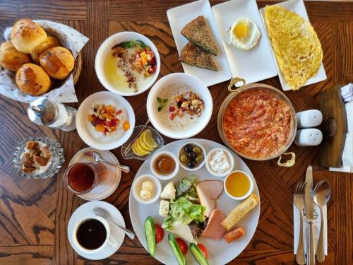 a wooden table with plates of food on it at Sultan Inn Boutique Hotel in Baku