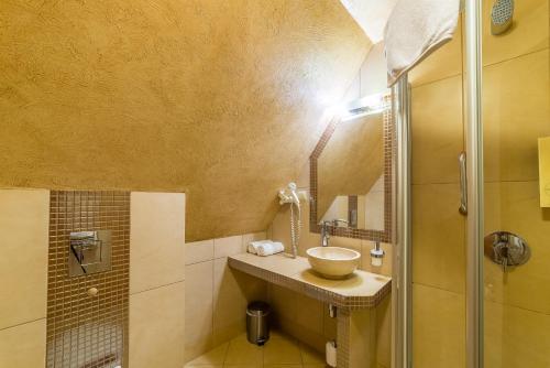 a bathroom with a sink and a shower at Hotel Burkaty in Białka Tatrzanska
