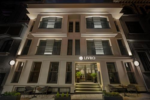 a large white building with a lit up entrance at Livro Hotel in Istanbul