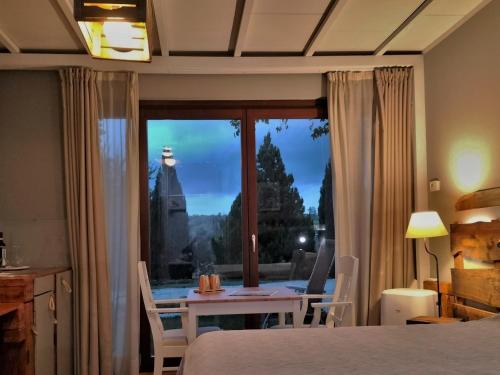 a bedroom with a bed and a table and a window at Ca'Luna in Mondovì