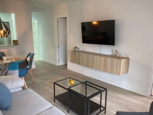 a living room with a tv on a wall at Octopus´Garden in La Herradura