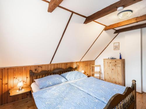 a bedroom with a blue bed with wooden walls at Holiday Home Richter by Interhome in Zistl