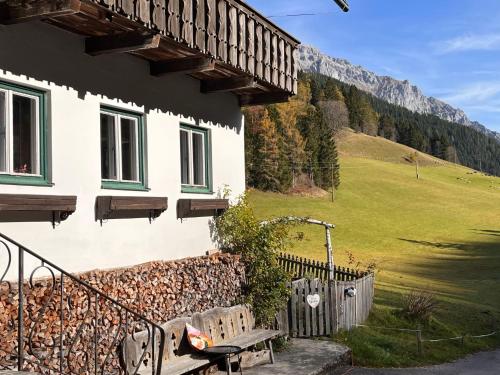 a house with a bench in front of it at Apartment Knaushof by Interhome in Ramsau am Dachstein