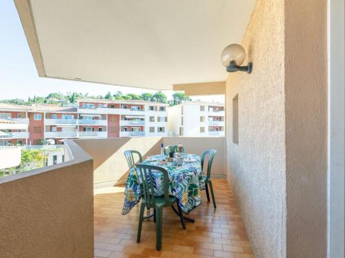 a dining room with a table and chairs on a balcony at Apartment Régina-2 by Interhome in Sainte-Maxime