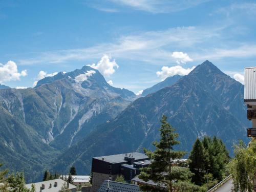 a view of the mountains from a city at Apartment Chalets du Soleil-21 by Interhome in Les Deux Alpes