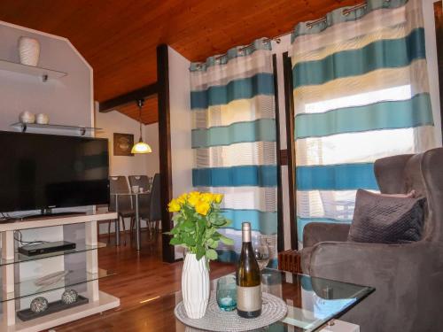 a living room with a couch and a television at Holiday Home Scout by Interhome in Machtlos