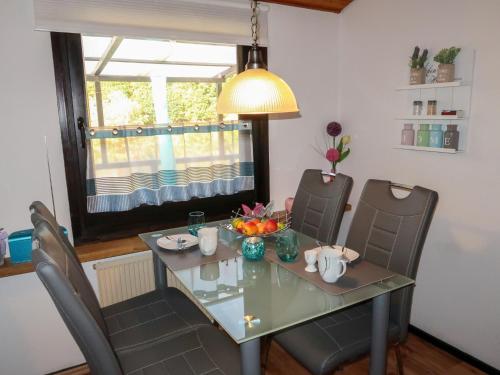 a dining room with a glass table and chairs at Holiday Home Scout by Interhome in Machtlos