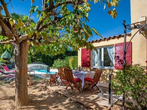 un patio avec une table et des chaises sous un arbre dans l'établissement Holiday Home Mas de L'Oulivier by Interhome, à Roussillon