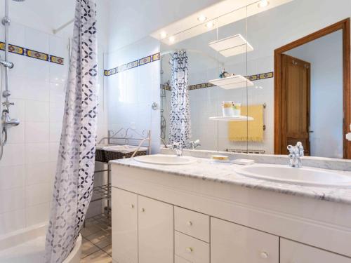 a bathroom with two sinks and a mirror at Holiday Home Les Vignes by Interhome in Ménerbes