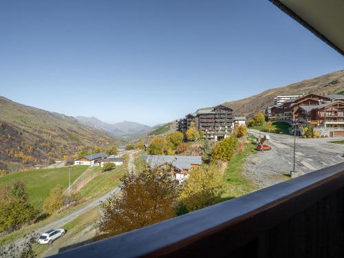 a view from a balcony of a town with a mountain at Apartment Le Sarvan-10 by Interhome in Les Menuires