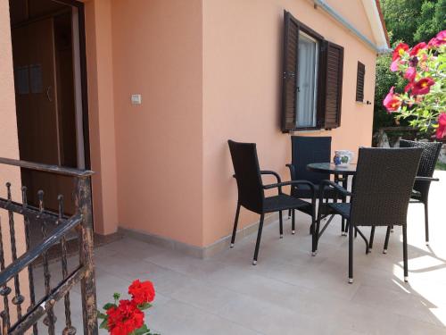a patio with chairs and a table on a balcony at Apartment Elsa - LBN109 by Interhome in Ravni