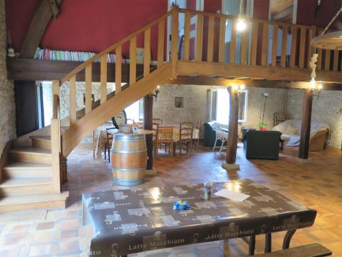 a living room with a staircase and a tasting room at Holiday Home La Raze by Interhome in Bonneville-et-Saint-Avit-de-Fumadières