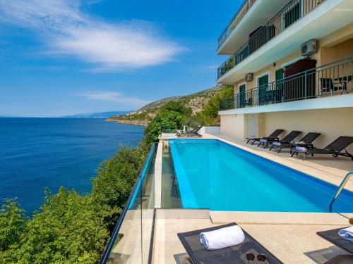 a hotel swimming pool with a view of the ocean at Apartment Marina-4 by Interhome in Senj