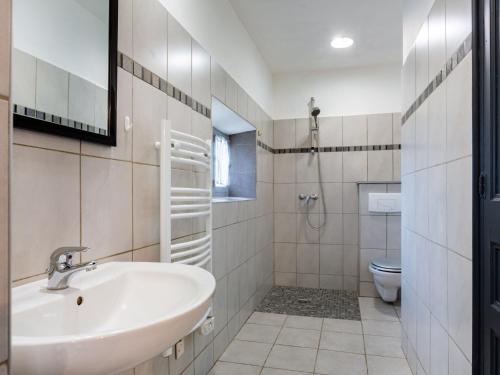 a bathroom with a sink and a toilet at Holiday Home L'Olivier by Interhome in Ménerbes