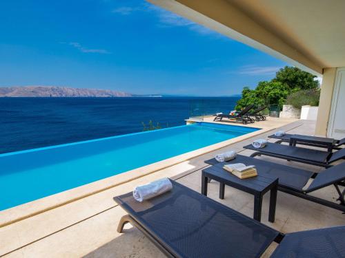 a villa with a swimming pool with a view of the ocean at Apartment Marina-6 by Interhome in Senj
