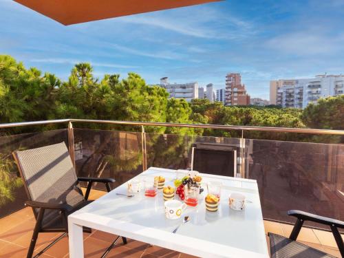 a white table and chairs on a balcony at Apartment Santa Cruz by Interhome in Blanes