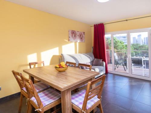 a dining room with a table and chairs and a couch at Apartment Santa Cruz by Interhome in Blanes