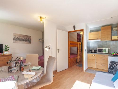 a living room with a table and chairs and a kitchen at Apartment Le Bochate-5 by Interhome in Saint-Pancrace