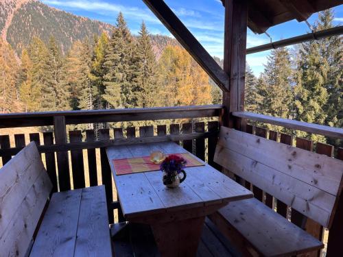 a picnic table on a porch with a view of the mountains at Chalet Wassertheureralm by Interhome in Greifenburg