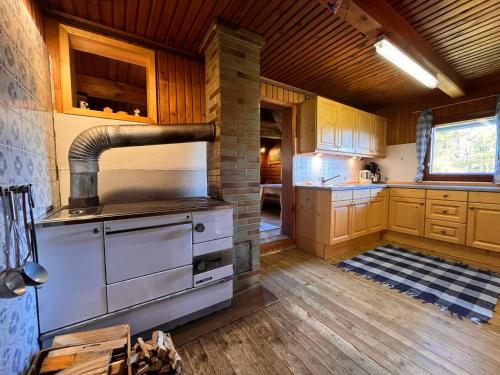 a kitchen with a large stove in a room at Chalet Wassertheureralm by Interhome in Greifenburg