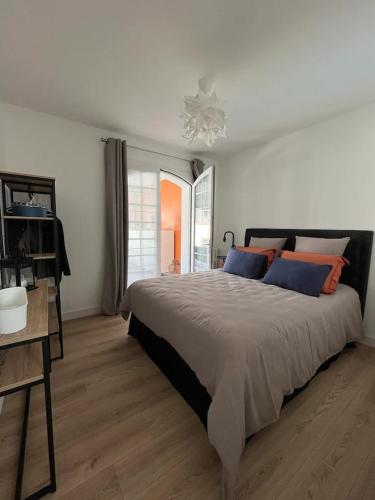 勒克魯西克的住宿－11 Port Lin，一间卧室配有一张带蓝色和橙色枕头的大床