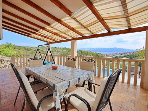 a table and chairs on a deck with a view at Holiday Home Villa Tonka by Interhome in Sutivan