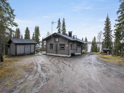 a house sitting on top of a dirt road at Holiday Home Villa helmi by Interhome in Ruka